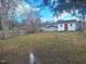 Large, grassy backyard featuring a shed at 614 Oak St, Burlington, NC 27215