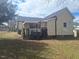 Backyard view of a charming home in a yard that needs landscaping attention at 614 Oak St, Burlington, NC 27215