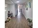 Bright hallway with unique art on the walls, wood flooring, and natural light from a window at 614 Oak St, Burlington, NC 27215