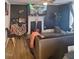 Living room with laminate floors, fireplace, a ceiling fan and blue walls at 614 Oak St, Burlington, NC 27215