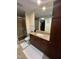 Well-lit bathroom with a large vanity mirror, updated fixtures, and neutral tile flooring at 618 N Boylan Avenue # 300, Raleigh, NC 27603