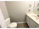 Cozy bathroom featuring a toilet, sink with cabinet and towel rack at 6221 Tributary Dr, Raleigh, NC 27609
