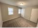 Carpeted bedroom with two windows and a closet at 6221 Tributary Dr, Raleigh, NC 27609