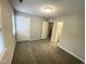 Carpeted bedroom with multiple doors and a window at 6221 Tributary Dr, Raleigh, NC 27609