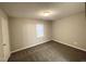 Bright carpeted bedroom featuring a window, light fixture and closet at 6221 Tributary Dr, Raleigh, NC 27609