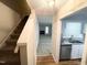 Foyer view features stairs and entry into kitchen and living room with fireplace at 6221 Tributary Dr, Raleigh, NC 27609