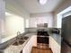 Updated kitchen with white cabinetry, granite countertops, and stainless steel appliances at 6221 Tributary Dr, Raleigh, NC 27609