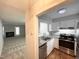 Kitchen view of granite counters, stainless steel appliances, and living room access at 6221 Tributary Dr, Raleigh, NC 27609
