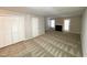 Spacious living room with fireplace, closet, neutral walls, and patterned carpet at 6221 Tributary Dr, Raleigh, NC 27609
