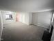 Open-concept living room with fireplace, access to kitchen, and neutral walls and carpeting at 6221 Tributary Dr, Raleigh, NC 27609