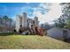 A backyard showcasing the home's exterior, two wooden decks, and a grassy yard at 6225 Tributary Dr, Raleigh, NC 27609