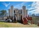 A backyard features a home's exterior and two decks surrounded by trees and greenery at 6225 Tributary Dr, Raleigh, NC 27609