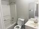 A bathroom includes a tub shower combo, toilet, and sink at 6225 Tributary Dr, Raleigh, NC 27609
