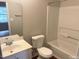 A full bathroom is shown with a tub, toilet, and sink at 6225 Tributary Dr, Raleigh, NC 27609