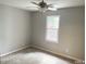The bedroom is bright with natural light, neutral walls, and soft carpet at 6225 Tributary Dr, Raleigh, NC 27609