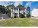 Neutral siding adorns this multi-Gathering unit with black shutters and tidy landscaping in a well-maintained yard at 6225 Tributary Dr, Raleigh, NC 27609