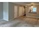 Comfortable living room area featuring neutral walls, plush carpet, and ceiling fan at 6225 Tributary Dr, Raleigh, NC 27609