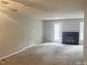 This bright living room has a decorative fireplace, neutral walls, and soft carpeting at 6225 Tributary Dr, Raleigh, NC 27609