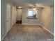 Cozy living area featuring neutral walls, plush carpet, and ceiling fan at 6225 Tributary Dr, Raleigh, NC 27609