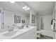 Bathroom featuring double sinks, a soaking tub and decorative mirror at 69 White Azalea Way, Homesite 81, Benson, NC 27504