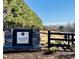 Stone entrance sign for Alder Creek community surrounded by lush trees at 69 White Azalea Way, Homesite 81, Benson, NC 27504