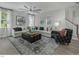 Bright living room featuring a decorative rug, stylish seating, and a large window at 69 White Azalea Way, Homesite 81, Benson, NC 27504