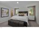 Comfortable bedroom with neutral walls, woven chest, and ensuite bathroom access at 69 White Azalea Way, Homesite 81, Benson, NC 27504