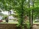 Discover the backyard with a patio, seating, and lush greenery, creating a perfect outdoor retreat at 730 Toms Creek Rd, Cary, NC 27519