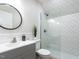This bathroom features a walk-in shower with white subway tile, a modern vanity, and a decorative mirror at 730 Toms Creek Rd, Cary, NC 27519