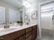 This bathroom showcases a double sink vanity, quartz countertops, and tile flooring with a walk-in shower at 730 Toms Creek Rd, Cary, NC 27519