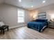 Bright bedroom featuring recessed lights, a window, and a comfortable bed with a blue patterned coverlet at 730 Toms Creek Rd, Cary, NC 27519