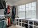 This walk-in closet boasts custom shelving and ample storage space and natural light from a large window at 730 Toms Creek Rd, Cary, NC 27519