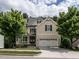 Beautiful two-story home with a well-manicured lawn, mature trees, and an attached two-car garage at 730 Toms Creek Rd, Cary, NC 27519