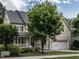 Charming two-story home featuring a manicured lawn, a two-car garage, and a welcoming front porch at 730 Toms Creek Rd, Cary, NC 27519