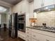 Modern kitchen with stainless steel appliances, double ovens, and granite countertops at 730 Toms Creek Rd, Cary, NC 27519