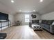 This living room features laminate wood floors, recessed lighting, and a comfortable sectional sofa at 730 Toms Creek Rd, Cary, NC 27519