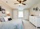 Relax in this main bedroom featuring carpet floors, a ceiling fan, and a neutral color palette at 730 Toms Creek Rd, Cary, NC 27519