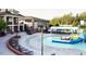 Inviting community pool area with ample seating and a fun water slide at 730 Toms Creek Rd, Cary, NC 27519