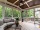 Cozy screened porch includes wood ceiling, heater, and comfortable furniture for enjoying peaceful outdoor living at 730 Toms Creek Rd, Cary, NC 27519