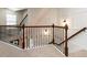 Elegant staircase with dark wood railings and detailed iron spindles at 730 Toms Creek Rd, Cary, NC 27519