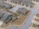 This aerial view showcases the neighborhood clubhouse, gardens, and surrounding well-maintained homes in this planned community at 74 Powderhorn Pt, Garner, NC 27529