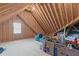 Spacious unfinished attic with wooden beams, plywood walls, and natural light at 74 Powderhorn Pt, Garner, NC 27529