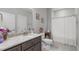 Well-lit bathroom with granite countertop, vanity, and shower with curtain at 74 Powderhorn Pt, Garner, NC 27529