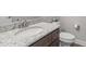 Bathroom vanity with white countertop, chrome faucet, and dark wood cabinets in a well-lit space at 74 Powderhorn Pt, Garner, NC 27529