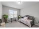 Bright bedroom with a daybed, cozy quilt, and a window letting in plenty of light at 74 Powderhorn Pt, Garner, NC 27529