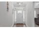 Bright foyer features wood-look flooring and decor at 74 Powderhorn Pt, Garner, NC 27529