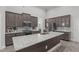 Spacious kitchen island with granite countertops, dark cabinets, and stainless appliances at 74 Powderhorn Pt, Garner, NC 27529