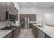 Modern kitchen with granite countertops, stainless appliances, and plenty of cabinet space at 74 Powderhorn Pt, Garner, NC 27529