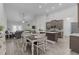 Open concept kitchen, dining, and living room with vaulted ceilings and hardwood floors at 74 Powderhorn Pt, Garner, NC 27529