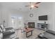 Bright living room featuring a fireplace, ceiling fan, and plush leather seating for a comfortable space at 74 Powderhorn Pt, Garner, NC 27529